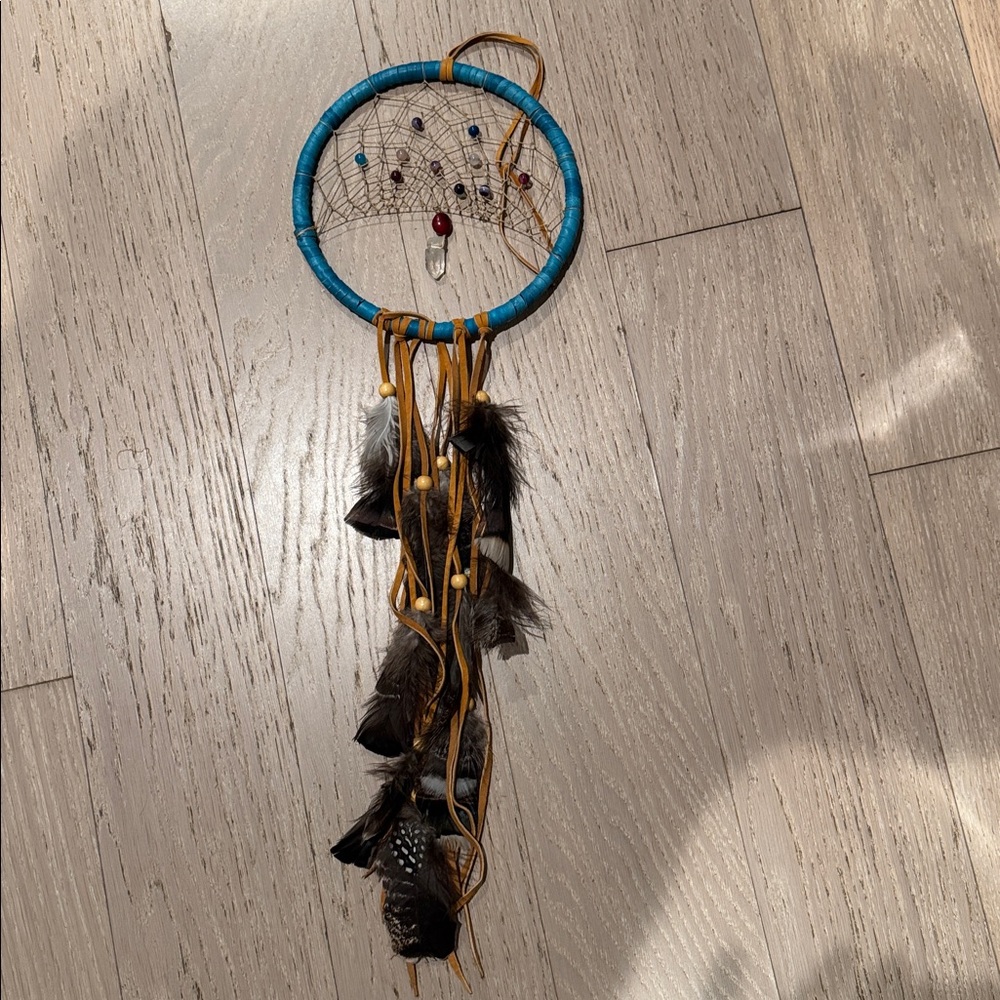 Homemade crystal, leather and feather dream catcher from Peru